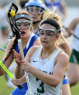 Fleming Island's Kierra Marquis keeps her stick close to her body while driving against Bolles